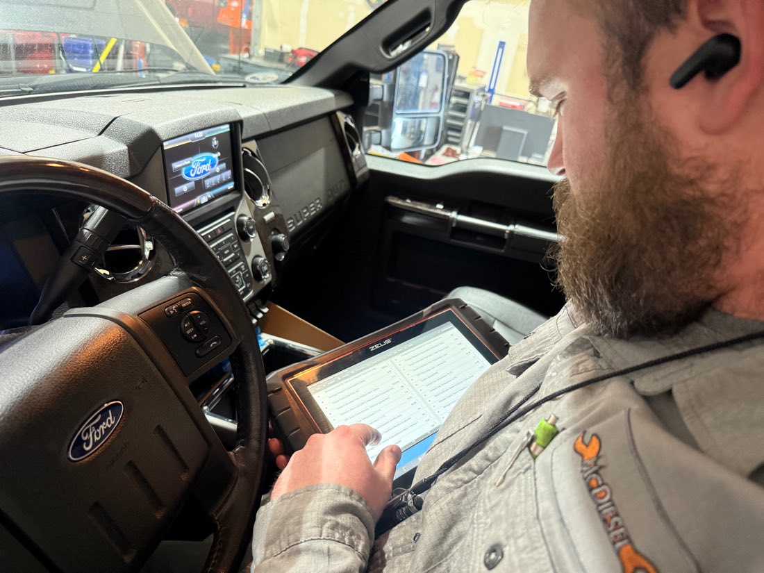 McDiesel tech scanning a check engine light in a Ford diesel truck in Sparks