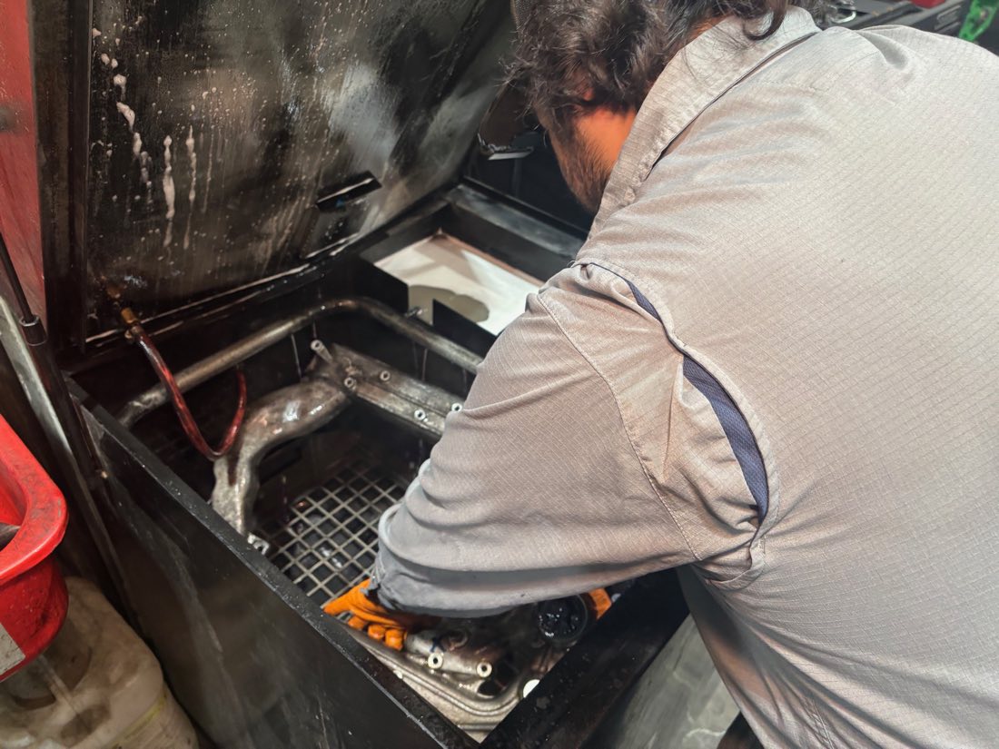 McDiesel tech working on a diesel engine in the Sparks shop
